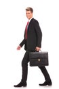 Business man holding brief case and walking Royalty Free Stock Photo