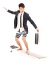 Business man holding a briefcase and standing surfing board Royalty Free Stock Photo