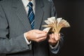 Business man is holding cash, fan of fifty euros. Person counts money. Businessman hands and euro bills Royalty Free Stock Photo