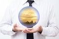 Business man holding a city inside a sphere, City of the future Royalty Free Stock Photo
