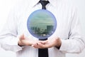 Business man holding a city inside a sphere, City of the future Royalty Free Stock Photo