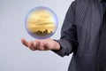 Business man holding a city inside a sphere, City of the future Royalty Free Stock Photo