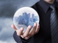Business man holding a city inside a sphere Royalty Free Stock Photo
