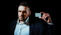 Business man holding credit card. Business card. Portrait of a businessman on black background. Man looking at camera Royalty Free Stock Photo