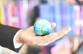 Business man holding earth globe model in hand and - Business global and travel around the world or save the world concept Royalty Free Stock Photo
