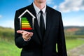 Business man holding an energetic house. Saving energy and eco environment concept Royalty Free Stock Photo