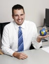 Business man holding a globe