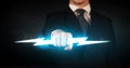 Business man holding glowing lightning bolt in his hands Royalty Free Stock Photo