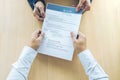 Business man holding his resume during job interview to Executive reading and consider, Hiring concept Royalty Free Stock Photo