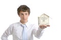 Business man holding a house made of money Royalty Free Stock Photo