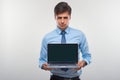 Business man holding a laptop against a white background Royalty Free Stock Photo