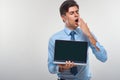 Business man holding a laptop against a white background Royalty Free Stock Photo