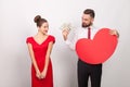 Business man holding many dollars and heart, cheerful woman embarrassed Royalty Free Stock Photo