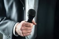 Business Man Holding Microphone. Public Speaking And Giving Speech In Suit For Audience Concept.