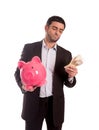 Business man holding piggy bank with money Royalty Free Stock Photo