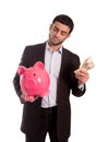 Business man holding piggy bank with money Royalty Free Stock Photo