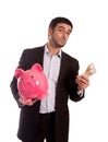 Business man holding piggy bank with money Royalty Free Stock Photo