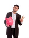 Business man holding pink piggy bank with money in hand Royalty Free Stock Photo