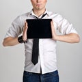 Business man holding and shows touch screen tablet pc with blank screen Royalty Free Stock Photo