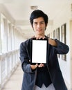 Business man holding and shows touch screen tablet pc Royalty Free Stock Photo