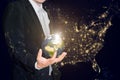 Business man holding the small world in his hands against america city night light.Save our planet earth ecology concept. Royalty Free Stock Photo