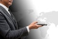 Business man holding smart phone with world map in background Royalty Free Stock Photo