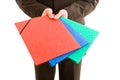 Business man holding three colourful folders Royalty Free Stock Photo