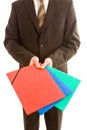 Business man holding three colourful folders Royalty Free Stock Photo