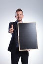 Business man holds a blackboard and shows ok Royalty Free Stock Photo