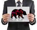 Business man holds paper with black silhouette bear financial icon.