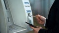 Business man inserting credit card in ATM to receive money, withdrawing cash Royalty Free Stock Photo