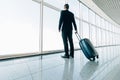 Business man at international airport moving to terminal gate for airplane travel trip. Mobility concept and aerospace industry fl Royalty Free Stock Photo