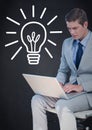 Business man with laptop against white lightbulb graphic and navy background Royalty Free Stock Photo