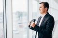 Business man looking with binoculars on competitors over panoramic windows Royalty Free Stock Photo