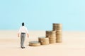 business man looking at coins stacks, success and earning concept Royalty Free Stock Photo