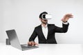Business man looking at data while sitting and wearing VR glasses. Deviation. Royalty Free Stock Photo