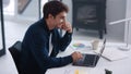 Business man looking documents on laptop. Smiling guy analyzing financial charts Royalty Free Stock Photo