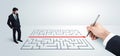 Business man looking at hand drawing solution for maze Royalty Free Stock Photo
