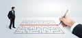 Business man looking at hand drawing solution for maze Royalty Free Stock Photo