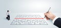 Business man looking at hand drawing solution for maze Royalty Free Stock Photo