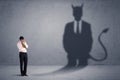 Business man looking at his own devil demon shadow concept Royalty Free Stock Photo