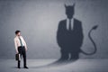 Business man looking at his own devil demon shadow concept Royalty Free Stock Photo