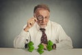 Business man looking through magnifying glass at dollar signs Royalty Free Stock Photo