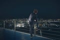 Businessman looks at the city during night. Future and new business opportunity concept