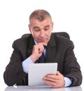 Business man looks pensively at his tablet Royalty Free Stock Photo