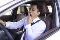 Business man looks tired yawning while driving the car Royalty Free Stock Photo