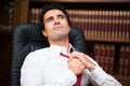 Business man loosing his necktie Royalty Free Stock Photo