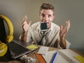 Business man in lose necktie messy and depressed working at laptop computer in business office problem suffering stress biting mob Royalty Free Stock Photo