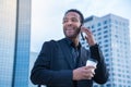 Business man making a phone call with smartphone outdoors on city street walking and talking Royalty Free Stock Photo