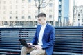 Business man. A man with a book and a laptop. The guy speaks through the phone on the street. The guy in the glasses makes notes i Royalty Free Stock Photo